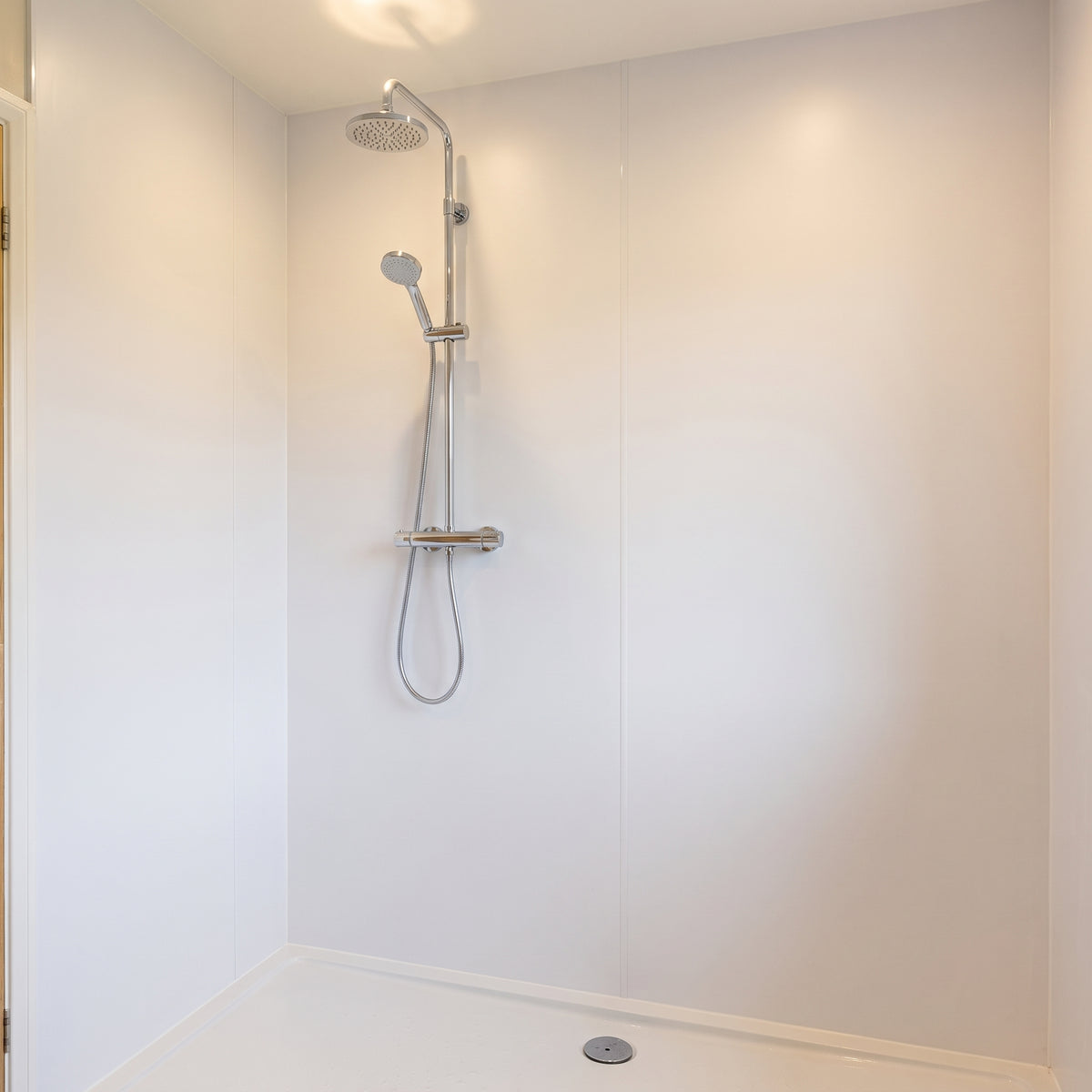 Large white PVC wall cladding sheets used as wipe-clean shower walls