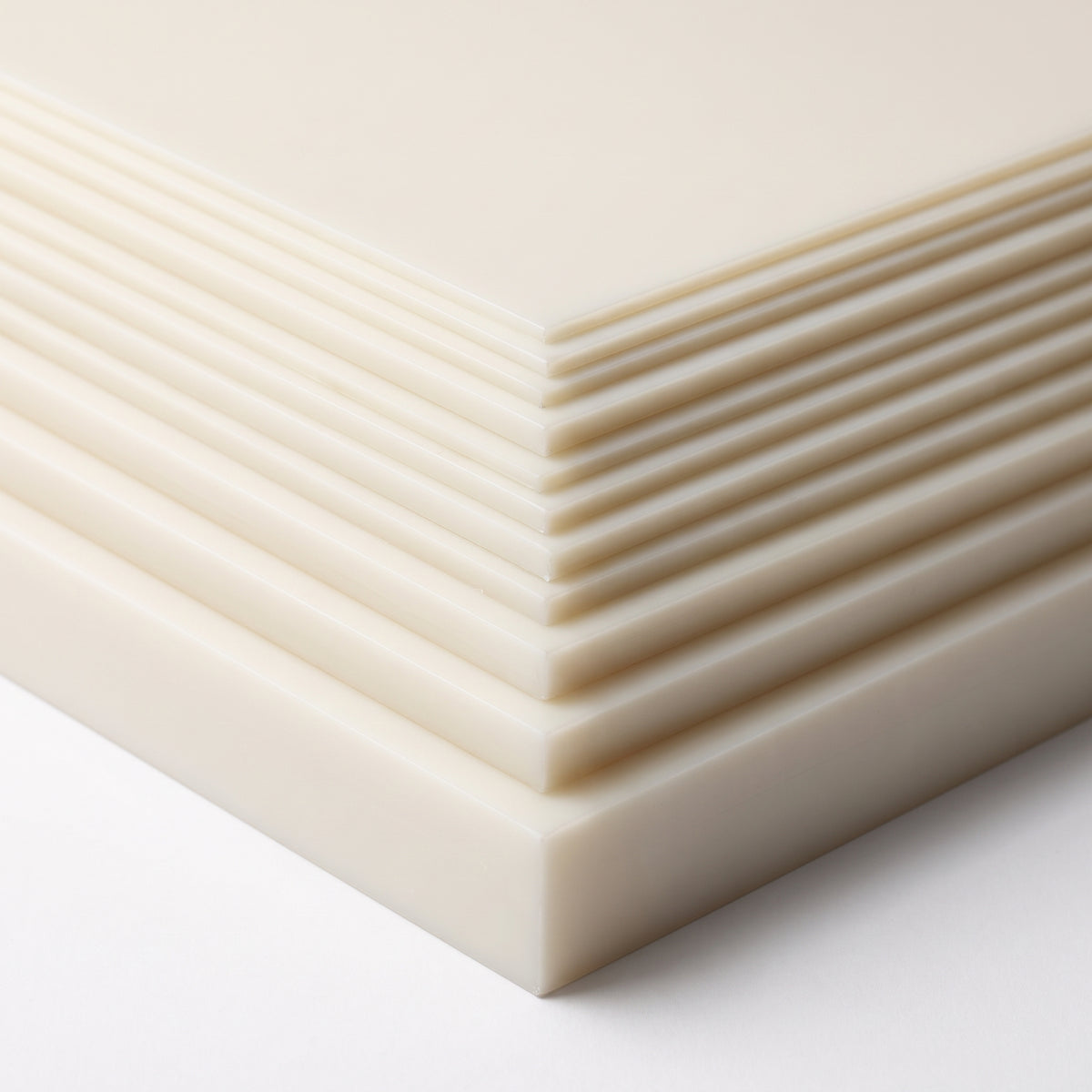 Stack of natural food-grade HDPE sheets in thicknesses from thin sheet to 60mm block