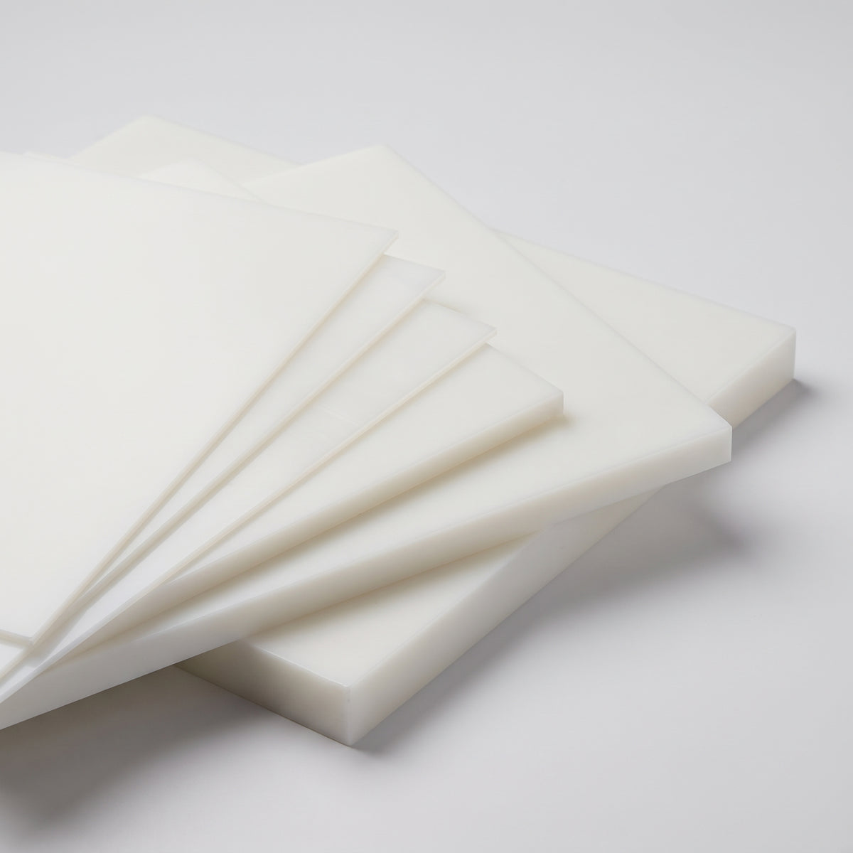 Natural polypropylene homopolymer (PPH) sheets in a range of thicknesses from 1mm to 50mm, fanned out to show the cut edges