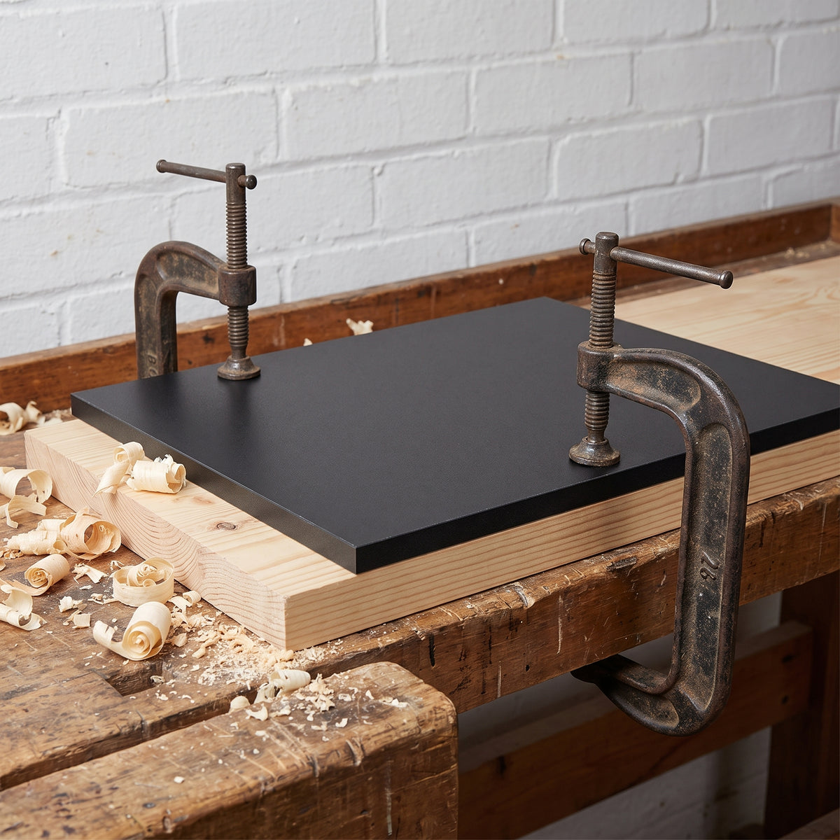 Tufnol 1P/13 SRBP sheet clamped to a pine board as a router straight-edge guide on a joinery bench