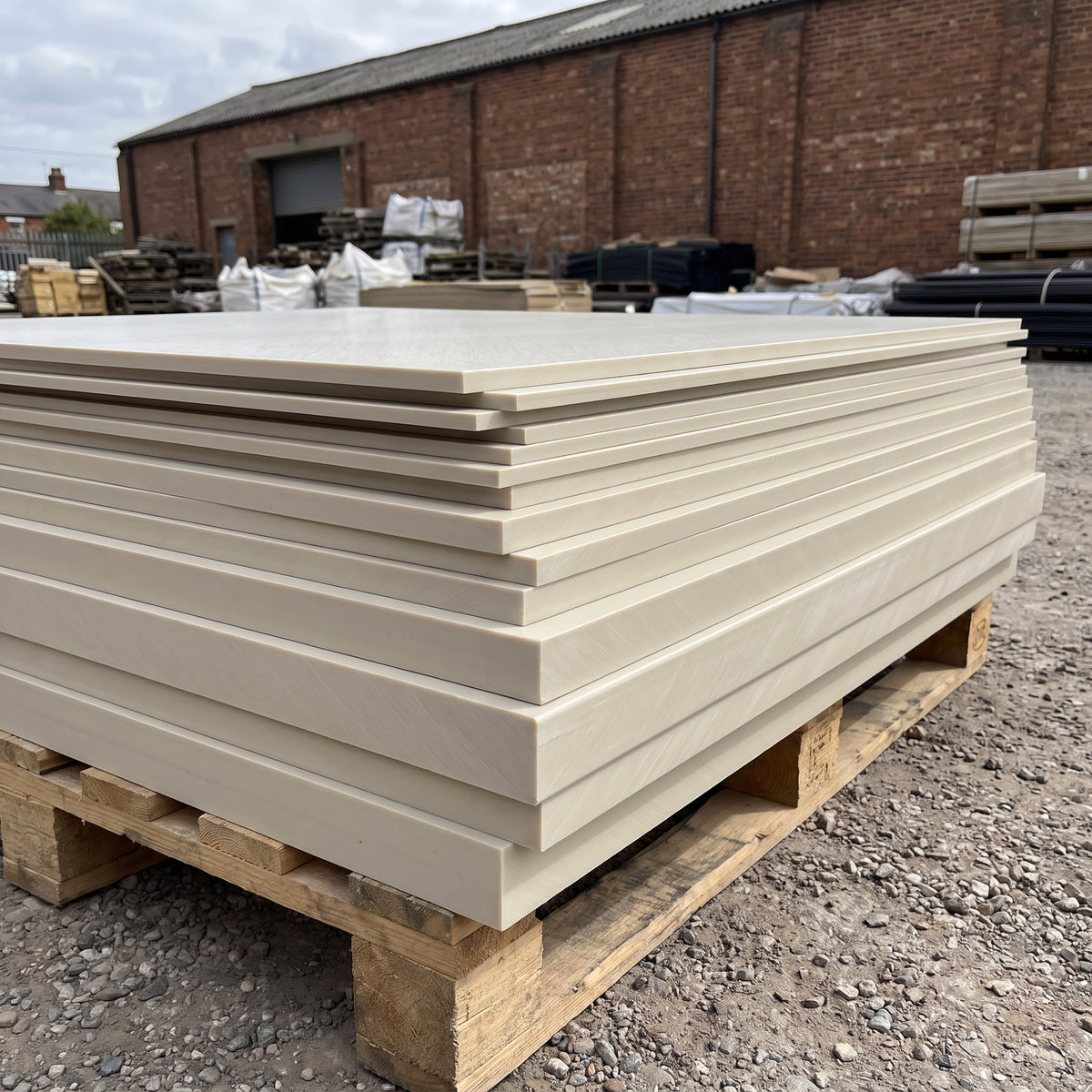 Stack of beige polypropylene homopolymer sheets in different thicknesses on a pallet