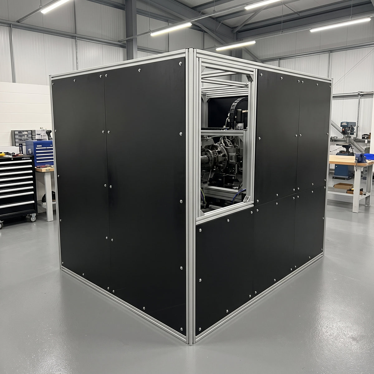 Machine guard enclosure made from black polypropylene sheet panels in an aluminium frame