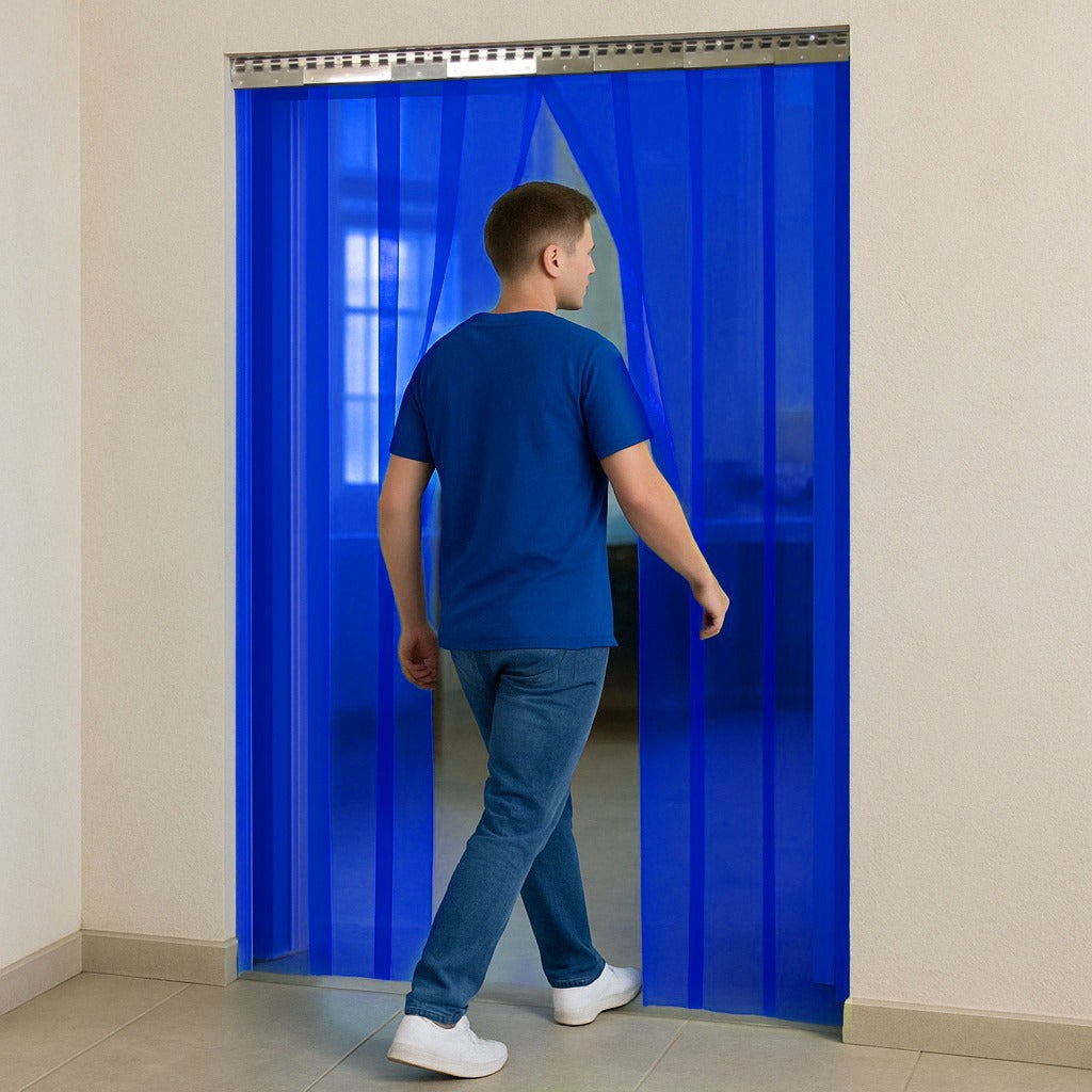 Person walking through transparent blue PVC strip curtain showing flexibility and transparency