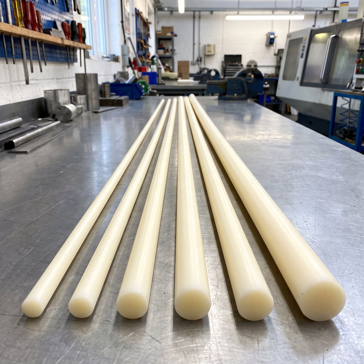 Precision ground natural Nylon 66 rods in full 3000mm lengths on a workshop bench