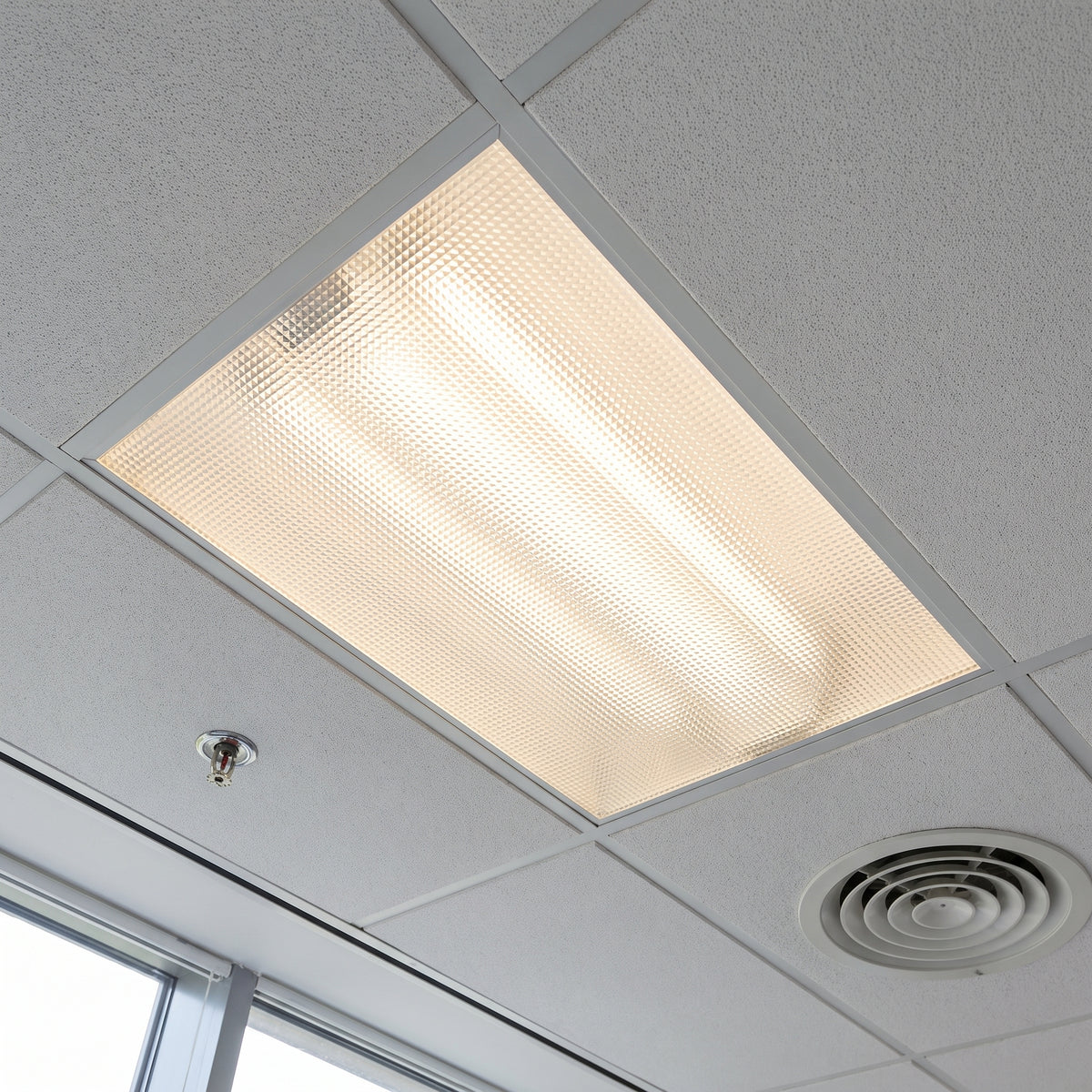Clear prismatic acrylic sheet as a diffuser in a ceiling light fitting