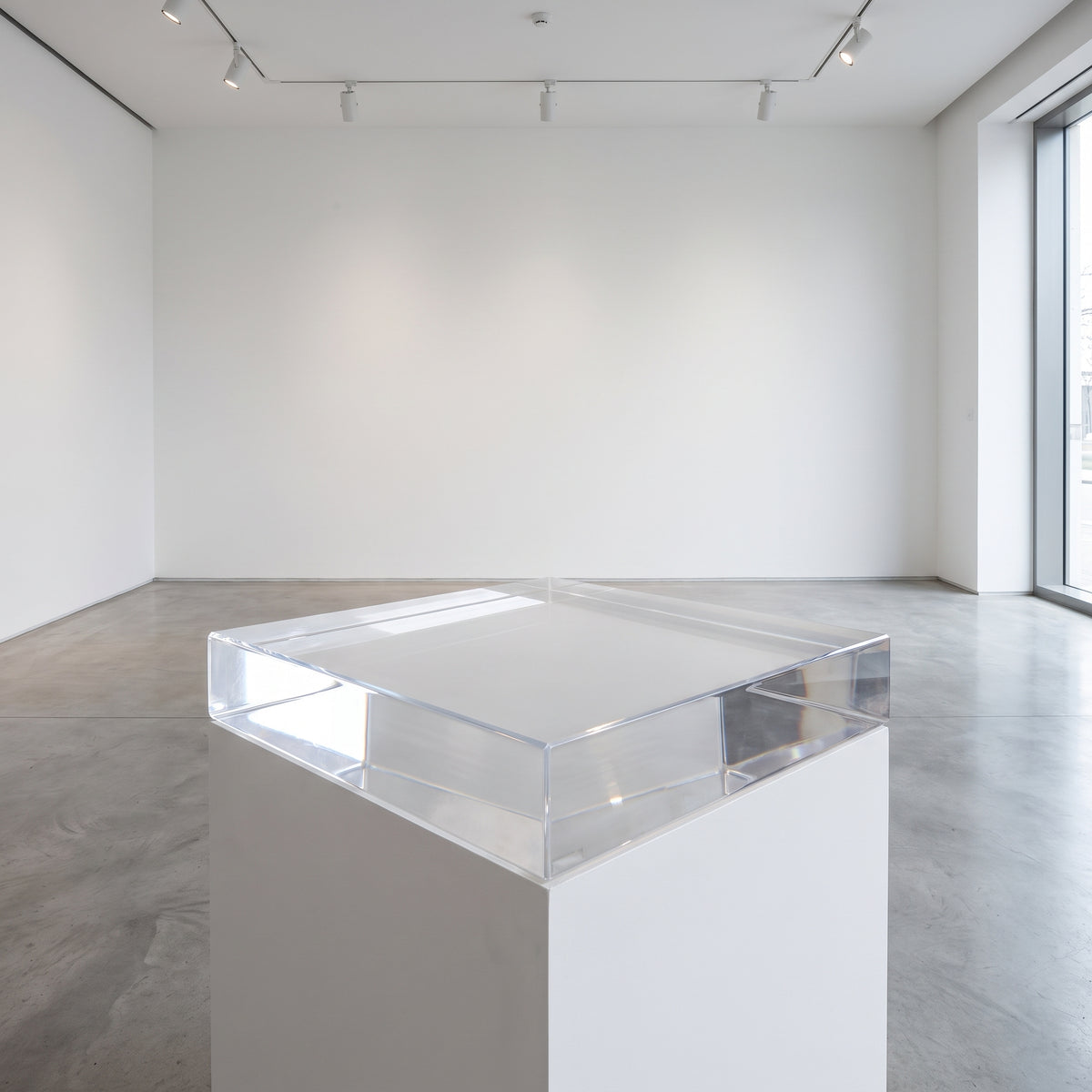 Thick clear acrylic block used as a display plinth, shown with polished edges (available on request)
